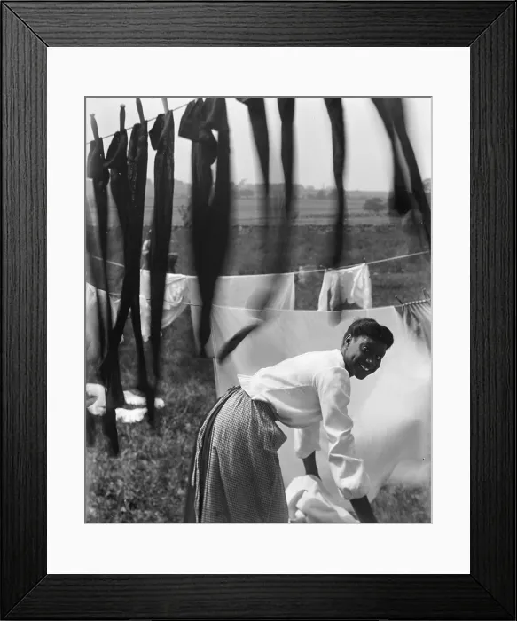Framed Print : A young African American woman working in the midst of clotheslines heavy with sheets and stockings, photograph by Gertrude Kasebier, 1902 Framed Print : A young African American woman working in the midst of clotheslines heavy with sheets and stockings, photograph by Gertrude Kasebier, 1902