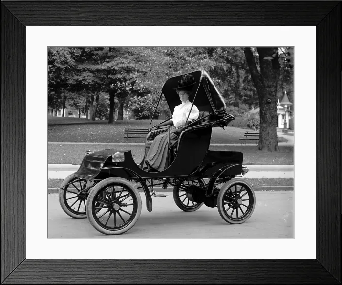 Framed Print : Woman driving electric car ca. 1910s