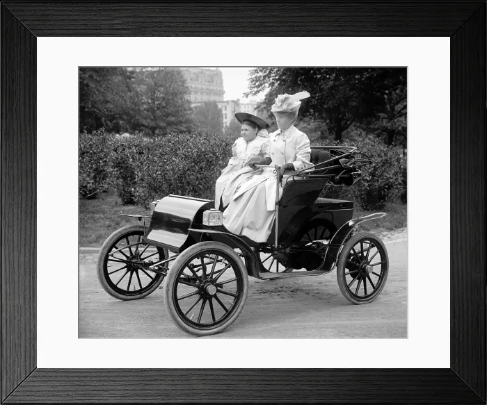 Framed Print : Woman driving automobile ca. 1910s