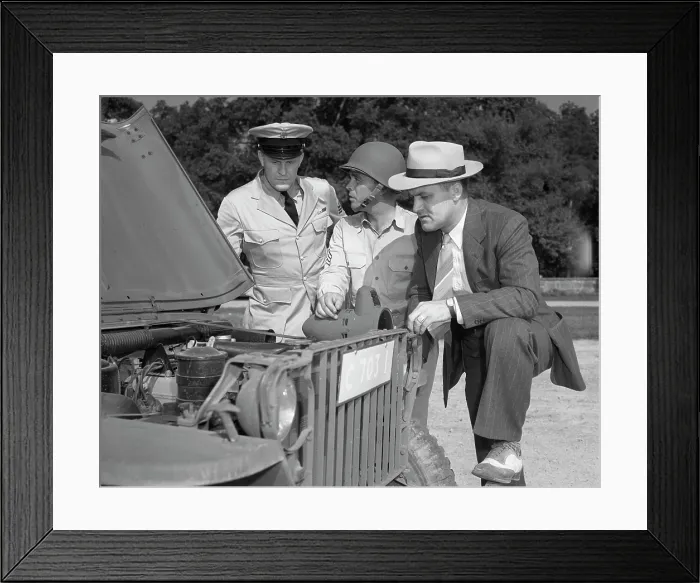 Framed Print : World War II, George Woolslayer (right) examining an army jeep at the post where Sergeant French L