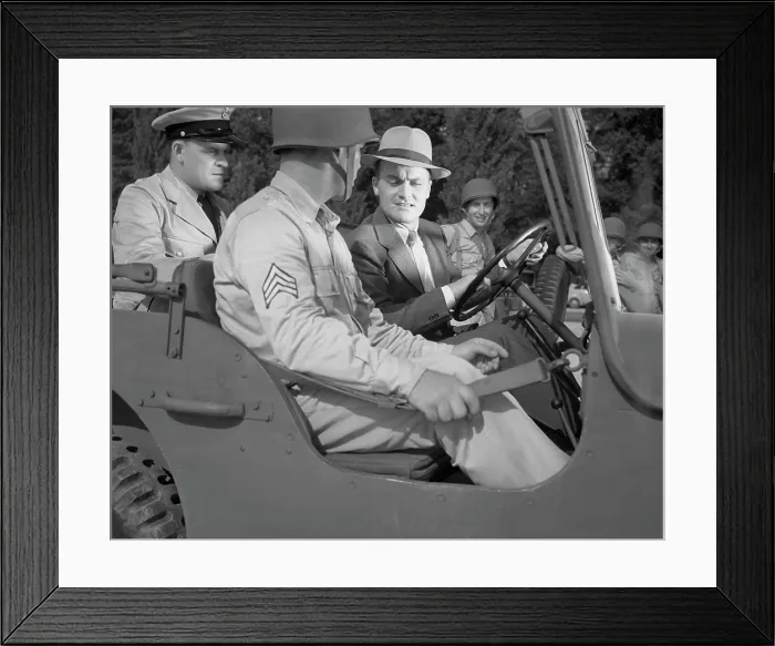 Framed Print : World War II, George Woolslayer (right) examining an army jeep at the post where Sergeant French L