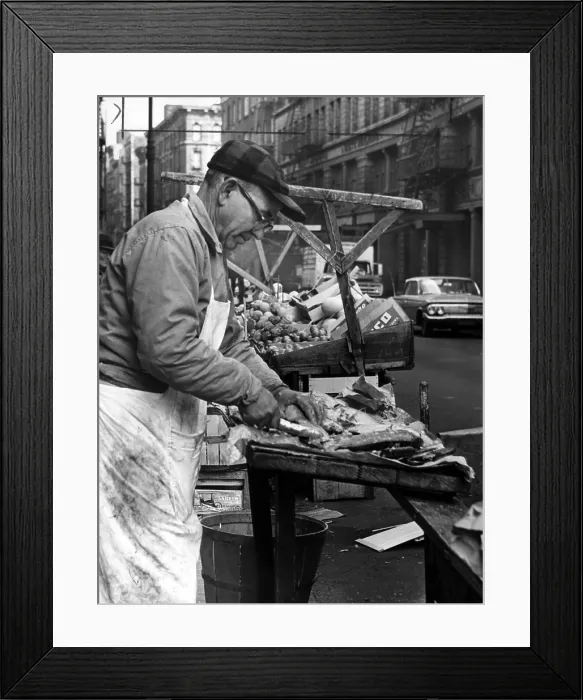 Framed Print : Little Italy, Charles Catalano cleaning fish at his pushcart on Hester & Mott streets, New York City, New York; photo by Phyllis Twachtman, 1964