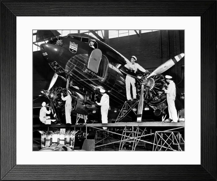 Framed Print : Mechanics give a United Airline's Mainliner airplane a routine checkup, 1943. Courtesy: CSU Archives / Everett Collection