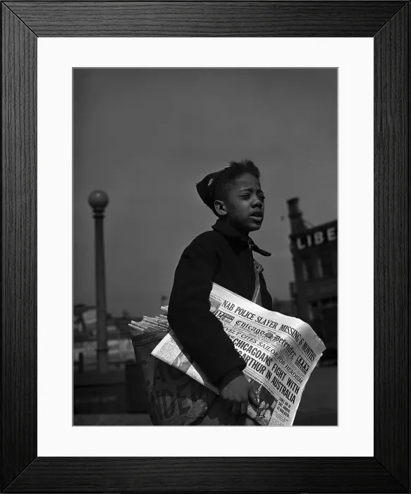 Framed Print : African American newsboy, original caption: Newsboy selling the Chicago Defender, a leading Negro newspaper, Chicago, Illinois, photograph by Jack Delano, April, 1942