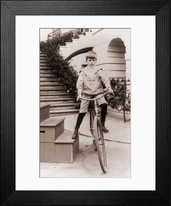 Framed Print : Archie Roosevelt, son of President Theodore and Edith, on a bicycle at the White House. Photo by Frances Benjamin Johnson, 1902