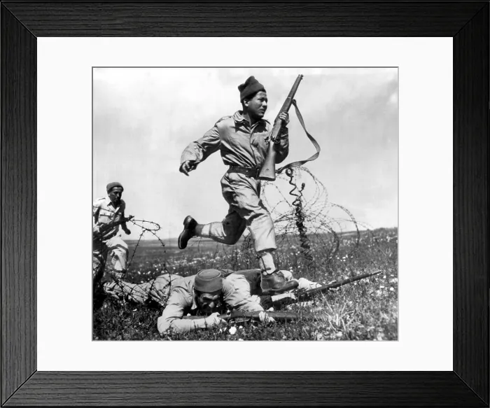Framed Print : TEL AVIV, PALESTINE, 1948: Israeli Haganah fighter dashes across a human bridge formed by two comrades over barbed wire obstacle.. Courtesy: CSU Archives  /  Everett Collection