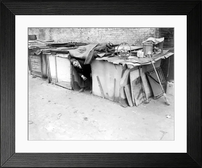 Framed Print : An unemployed man living in a shack constructed from packing cases and pieces of wood in New York City, off Broadway on West Houston Street. February 8, 1933 Framed Print : An unemployed man living in a shack constructed from packing cases and pieces of wood in New York City, off Broadway on West Houston Street. February 8, 1933