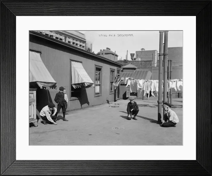 Framed Print : Boys playing games on the roof of a skyscraper, titled: Living on a skyscraper circa 1920s