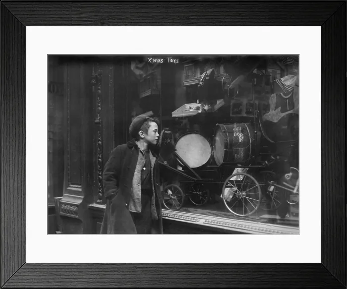 Framed Print : Boy looking through window at Christmas toys, titled: Xmas Toys, circa 1900s