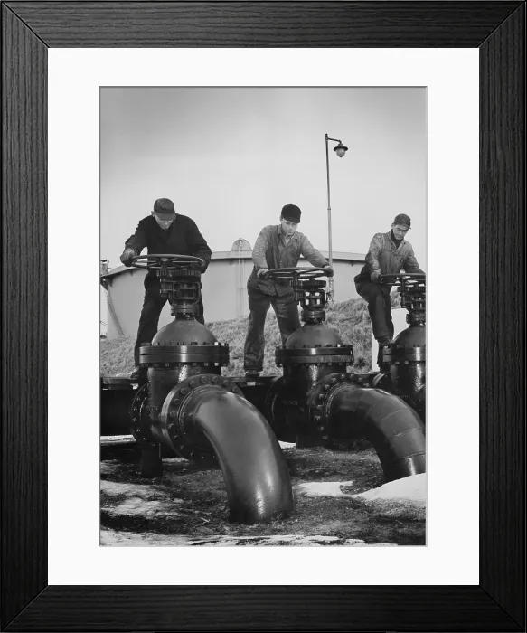 Framed Print : Men turn the wheels of large valves that regulate the flow of oil into oil tankers at a U.S. Atlantic coast seaport. Ca. 1944