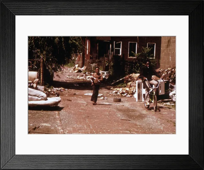 Framed Print : 1970s America. Two young boys pass through a trash-strewn alley of Chicago, ca. early 1973s Framed Print : 1970s America. Two young boys pass through a trash-strewn alley of Chicago, ca. early 1973s