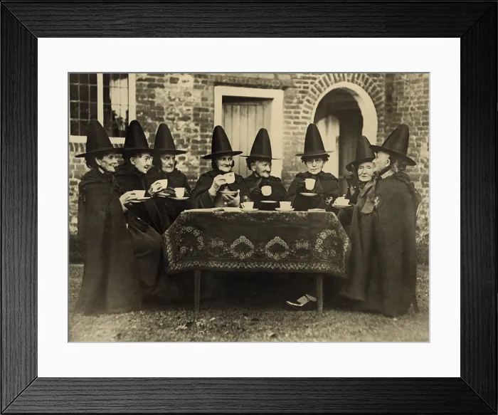 Framed Print : Eight women in high hats having tea. They are not a group of witches but the members of the Holy and Undivided Trinity of Castle Rising, Norfolk, England. Ca. 1920 Framed Print : Eight women in high hats having tea. They are not a group of witches but the members of the Holy and Undivided Trinity of Castle Rising, Norfolk, England. Ca. 1920