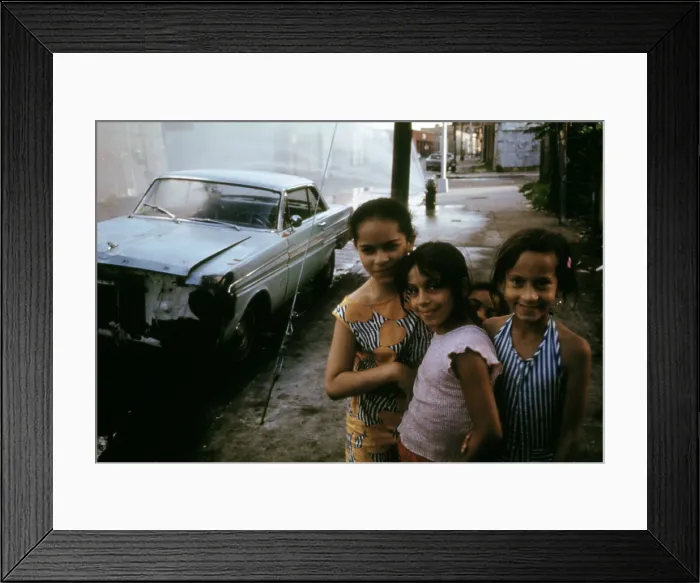 Framed Print : 1970s America. Three young girls pose in front of an abandoned car in Brooklyn, New York City, ca. 1973
