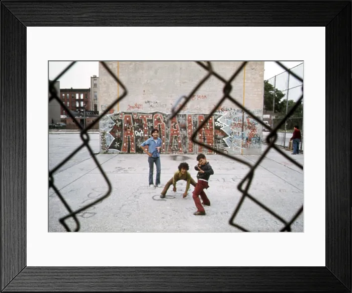 Framed Print : 1970s America. Three young boys pose in front of a graffitied wall in a park in Brooklyn, New York City, ca. 1973
