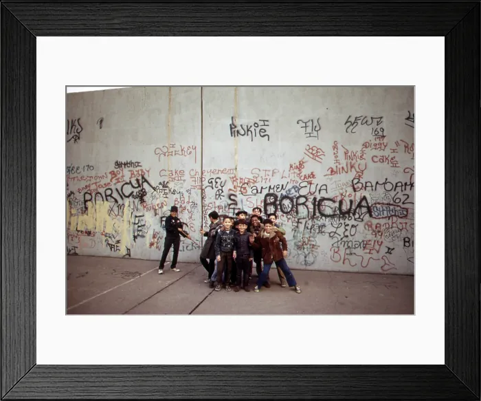 Framed Print : 1970s America. Young boys pose in front of a graffitied wall in a park in the Bronx, New York City, ca. 1973