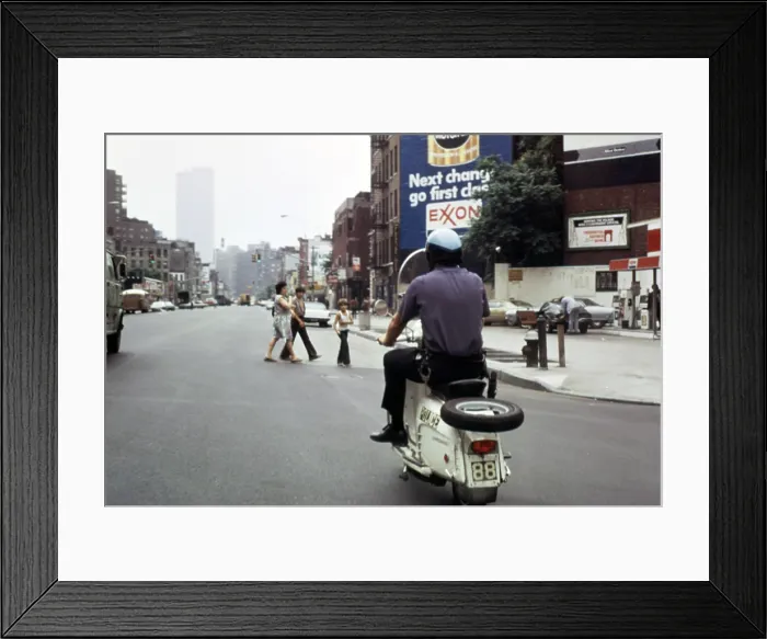 Framed Print : 1970s America. A New York City police officer on a scooter. 7th Avenue at 8th Street, Manhattan, New York City, ca. 1972 Framed Print : 1970s America. A New York City police officer on a scooter. 7th Avenue at 8th Street, Manhattan, New York City, ca. 1972