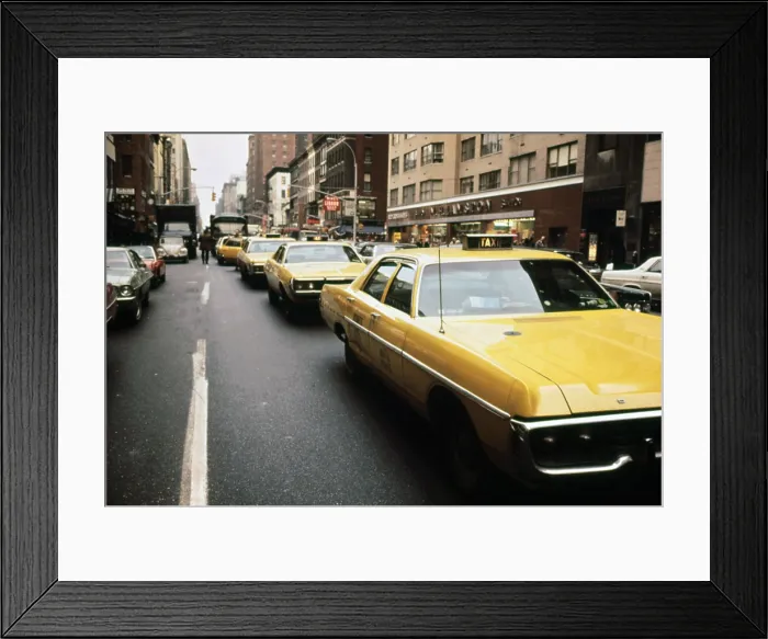 Framed Print : 1970s America. Yellow taxi cabs on Lexington Avenue at 61st Street. Manhattan, New York City, ca. 1972