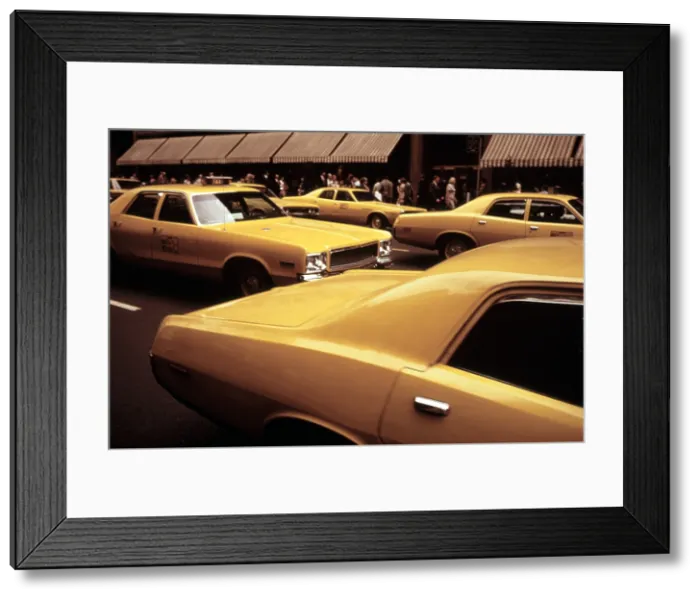 Framed Print : 1970s America. Yellow taxi cabs on 5th Avenue near 48th Street. Manhattan, New York City, ca. 1972