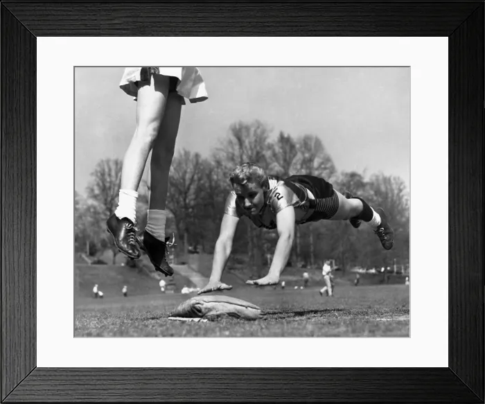 Framed Print : Linda McConkey, of the Atlanta's Lorelei Ladies softball team, diving for third base. The legs belong to Atlanta Tomboys third basewoman, Jerrie Rainey. Atlanta, Georgia Framed Print : Linda McConkey, of the Atlanta's Lorelei Ladies softball team, diving for third base. The legs belong to Atlanta Tomboys third basewoman, Jerrie Rainey. Atlanta, Georgia