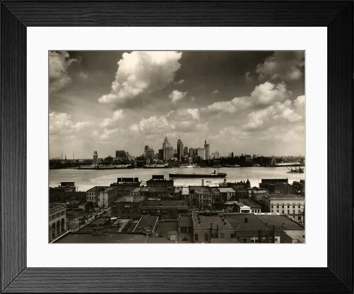 Framed Print : Detroit. The Detroit skyline and boats on the Detroit River as seen from Windsor, Ontario. In foreground, rooftops of buildings in Windsor. 1929