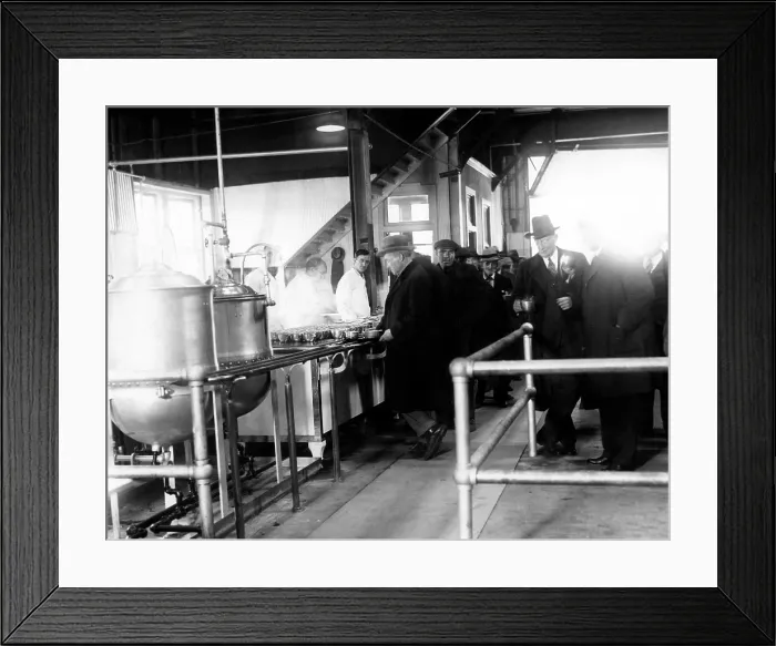 Framed Print : Men wait in line for food at a municipal lodging house. Police Commissioner Edward P. Mulrooney stands with coffee (second from right), New York City, 1930