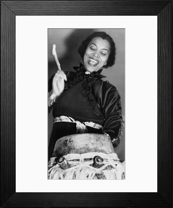 Framed Print : Zora Neale Hurston (1891-1960), African American author and folklorist, beating the hountar, or mama drum. 1937
