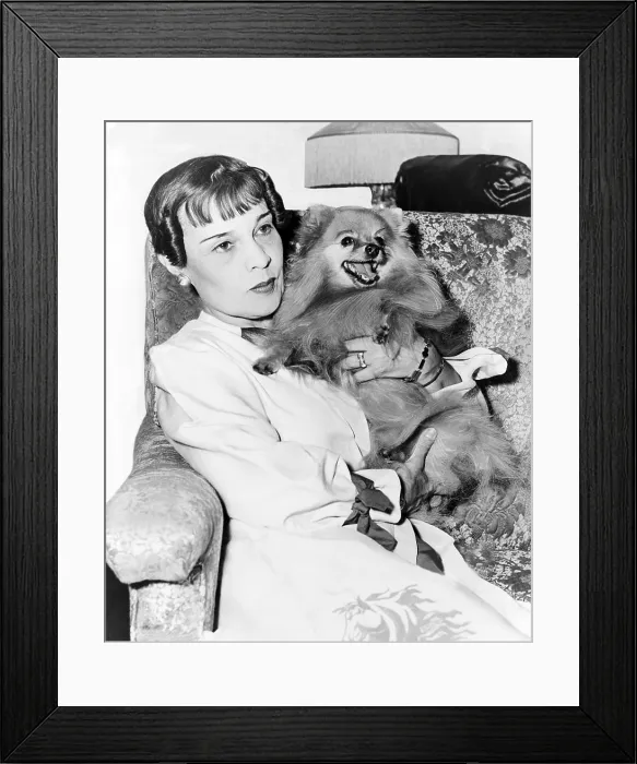 Framed Print : Anita Loos (1893-1981) American author and screenwriter, best known for her 1926 novel GENTLEMEN PREFER BLONDS. Loos is holding her dog, James Cagney. 1953