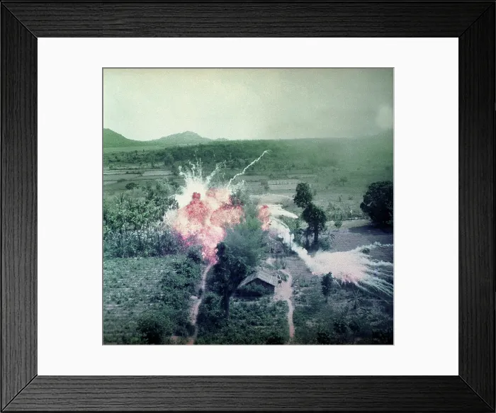 Framed Print : Vietnam War, Napalm bombs explode on Viet Cong structures south of Saigon in the Republic of Vietnam, circa late 1960s