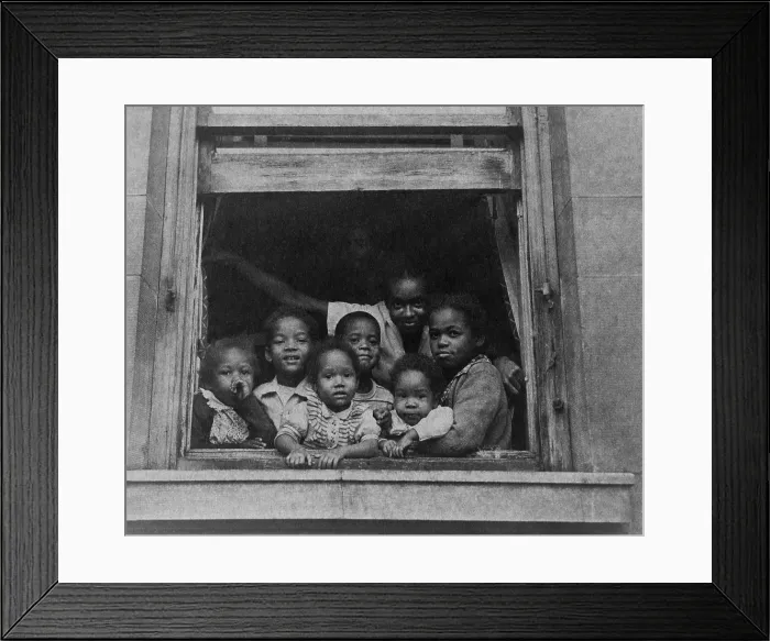 Framed Print : African American woman and six children at window of a city apartment building ca. 1950