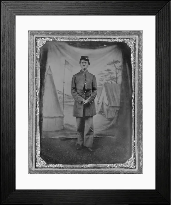 Framed Print : African American soldier posed in front of quaint studio backdrop of tents in a military camp with a prominent U.S. flag