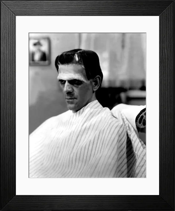 Framed Print : FRANKENSTEIN, Boris Karloff in makeup chair wearing makeup for the film, 1931