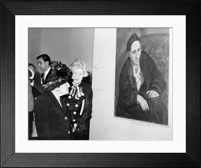 Framed Print : Janet Flanner (1892-1978) standing with Alice B. Toklas (1877-1967) in front of Picasso's portrait of Gertrude Stein (1874-1946). 1955. Image has fine art copyright