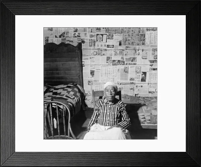 Framed Print : Elderly former slave in her sitting in her news papered home in May 1941. The beds are covered with handmade quilts. Greensboro, Alabama, May 1941 Framed Print : Elderly former slave in her sitting in her news papered home in May 1941. The beds are covered with handmade quilts. Greensboro, Alabama, May 1941