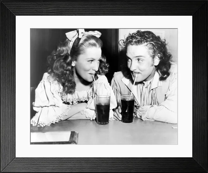 Framed Print : FRENCHMAN'S CREEK, from left: Joan Fontaine, Arturo de Cordova refreshing themselves on set, 1944