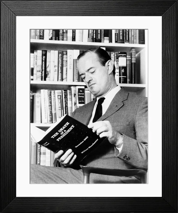 Framed Print : William Manchester (1922-2004), American biographer and historian, holding a copy of his book