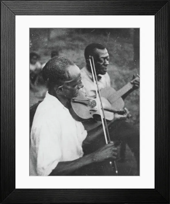 Framed Print : Stavin Chain playing guitar and singing accompanied by a musician on violin, Lafayette, La. June 1934