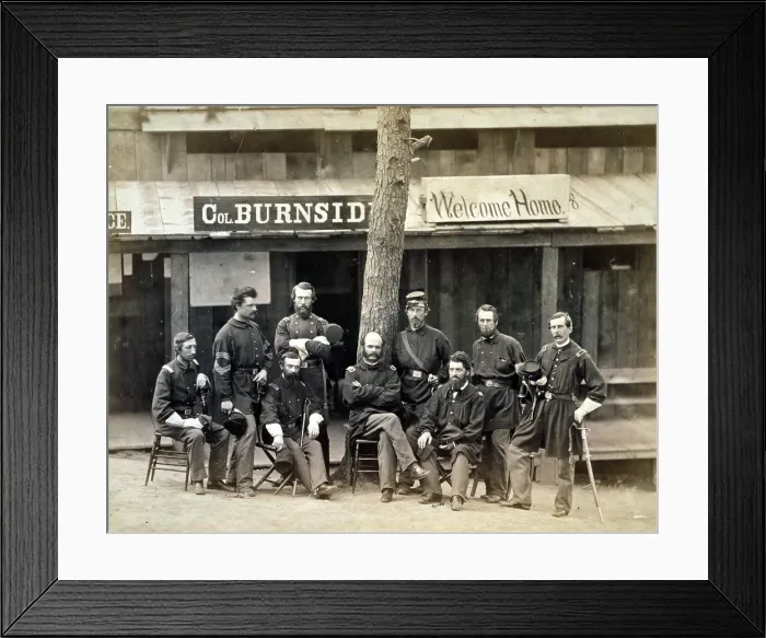 Framed Print : Civil War. Ambrose Everett Burnside with eight officers of the lst Rhode Island Volunteers in front of building, with sign reading 'Col