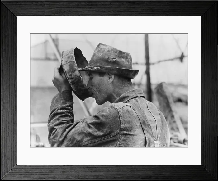Framed Print : Oil field worker drinking water from a crude metal container, Kilgore, Texas. 1939 Photo by Russell Lee