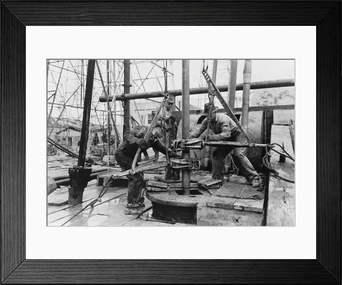 Framed Print : Oil rig workers, called roughnecks, at work, loosening sections of pipe on an drilling platform, Kilgore, Texas. 1939 Photo by Russell Lee