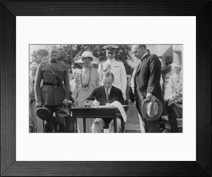 Framed Print : President Calvin Coolidge (1872-33) signing appropriation bills for the Veterans Bureau on the south lawn during the garden party for wounded veterans in 1924. Mrs