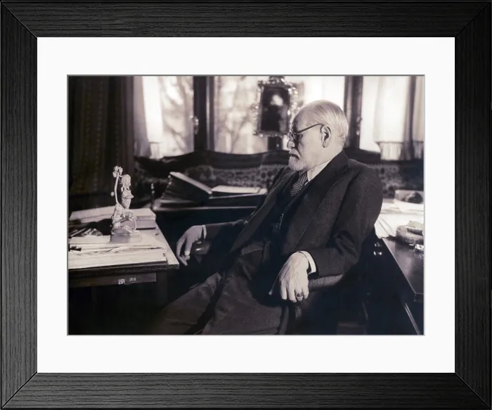 Framed Print : Sigmund Freud seated in his study contemplating a carved figurine (possibly Javanese) on his desk in 1937 photography by Princess Marie Bonaparte Framed Print : Sigmund Freud seated in his study contemplating a carved figurine (possibly Javanese) on his desk in 1937 photography by Princess Marie Bonaparte