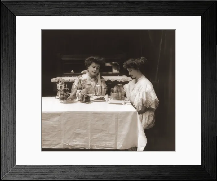 Framed Print : General Electric advertising photo of women using electric appliances, a toaster, coffeepot and egg poacher. Ca. 1908