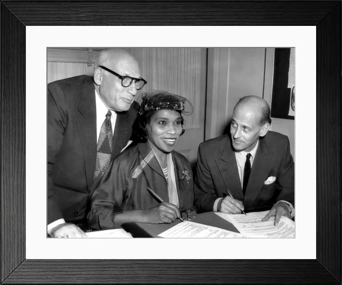 Framed Print : Singer Marian Anderson signs a contract with Metropolitan Opera representative Rudolf Bing (right). She was the first black performer to sing leading roles for the Met