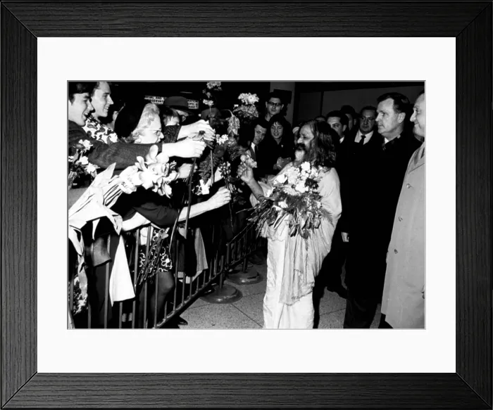 Framed Print : MAHARISHI MAHESH YOGI, head of the spiritual regeneration movement, accepts flowers from his followers, greeting his arrival at a NY airport, January 18, 1968 Framed Print : MAHARISHI MAHESH YOGI, head of the spiritual regeneration movement, accepts flowers from his followers, greeting his arrival at a NY airport, January 18, 1968