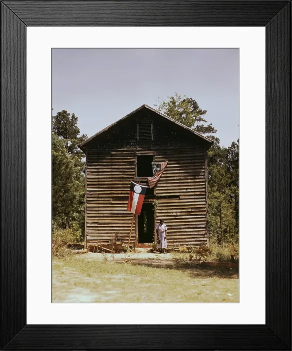 Framed Print : African American woman standing by building with Georgia state and United States flags, near White Plains, Georgia, photograph by Jack Delano, March, 1941