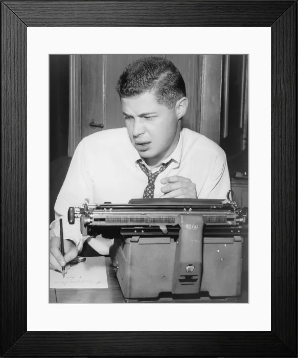 Framed Print : George Axelrod (1922-2003), playwright and screenwriter, seated at typewriter