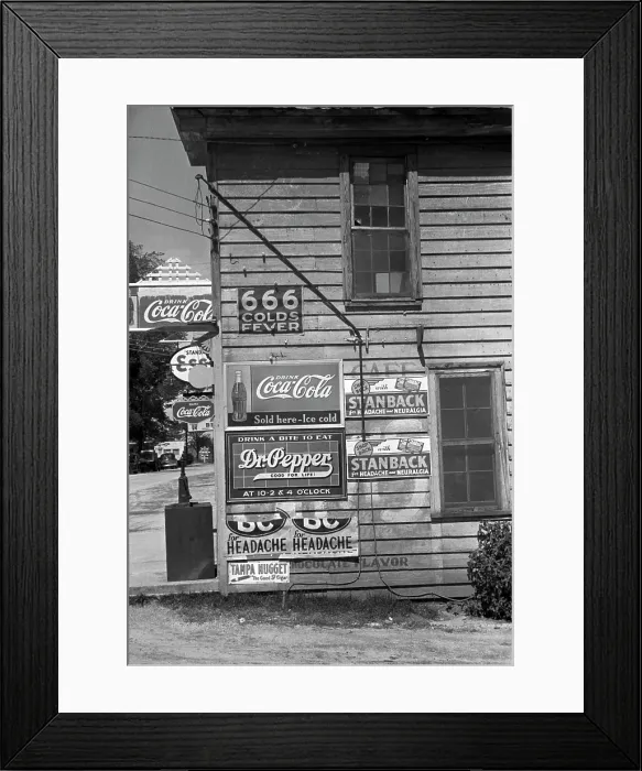 Framed Print : Side of a store, showing advertising signs, including 666 cold medicine, Dr. Pepper, Coca-Cola, Esso Gasoline, Halifax, North Carolina, photograph by John Vachon, April, 1938