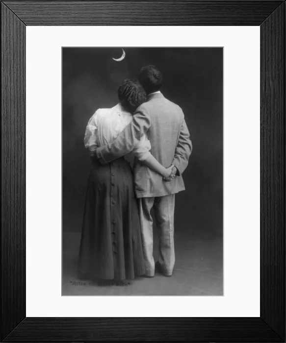 Framed Print : Shine on Silver Moon, rear view of man and woman, standing, full length, with arms around each other, looking at the moon, photograph circa 1909