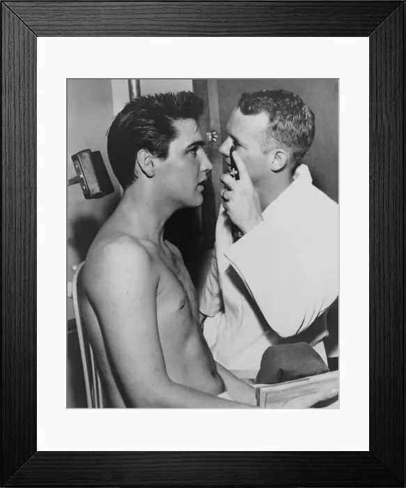 Framed Print : Elvis Presley, while being examined by Dr. Fred Jeff Burford, as part of induction into the army. 1958