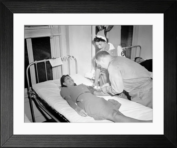Framed Print : Blood Transfusion. A volunteer blood donor giving her blood at a Red Cross donor center